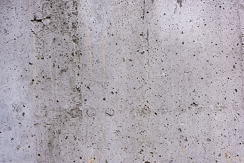 full frame view of grey rough scratched concrete wall texture