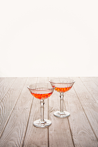 close-up shot of glasses of wine on wooden table on white