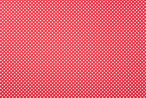 Texture of polka dot pattern on red background