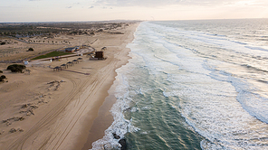 aerial view of dramatic empty sandy beach with wavy sea, Ashdod, Israel