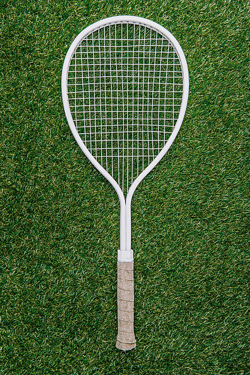 유토이미지 | top view of white tennis racket lying on green grass