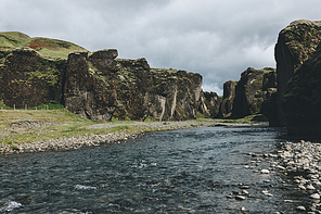 scenic view of beautiful mountain river flowing through highlands in Fjadrargljufur Canyon in Iceland