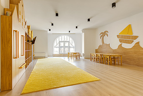 cozy light classroom with wooden furniture in modern kindergarten