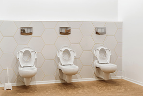 clean white toilet bowls in toilet in modern kindergarten