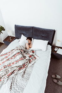 high angle view of young man sleeping in bed at home