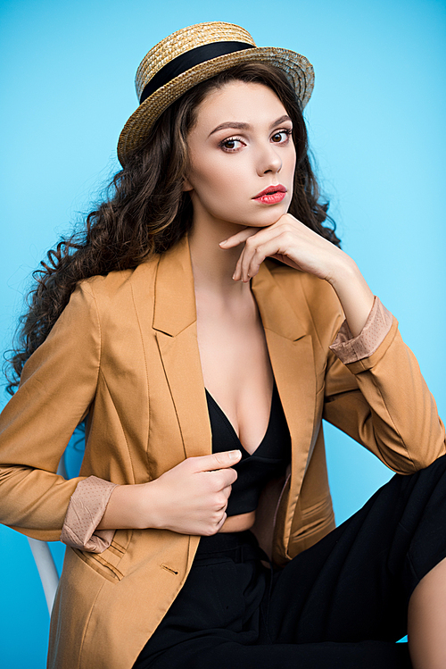 attractive young woman in canotier hat and stylish jacket 