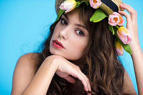 sensual young woman in canotier hat with beautiful tulips under it