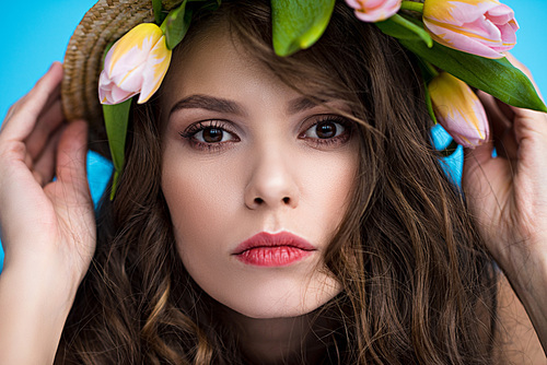 young woman in canotier hat with beautiful tulips under it 