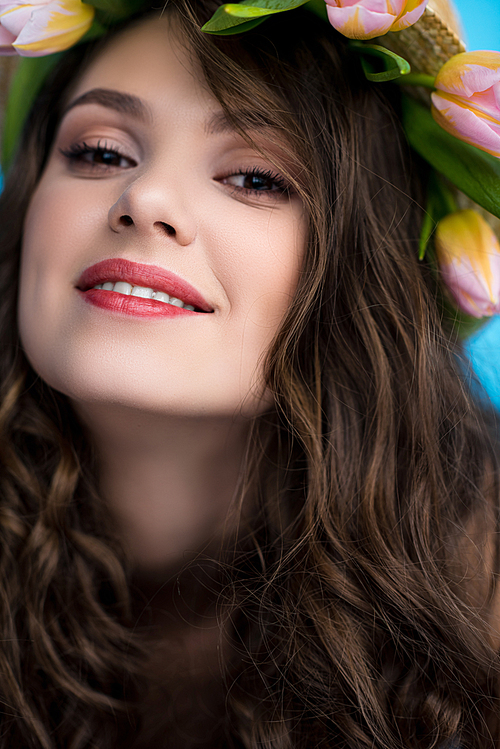 close-up portrait of attractive young woman with wreath made of tulip flowers