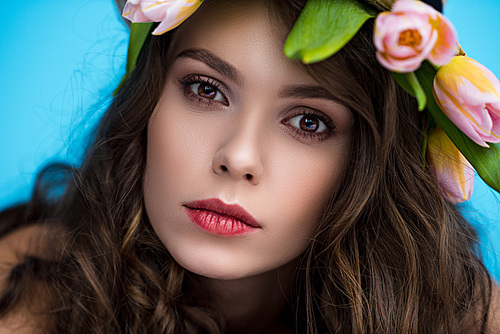 close-up portrait of sensual young woman with wreath made of tulip flowers