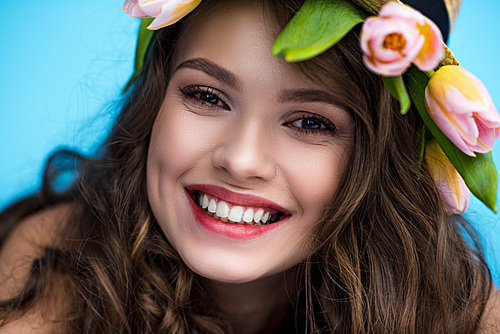 close-up portrait of happy young woman with wreath made of tulip flowers