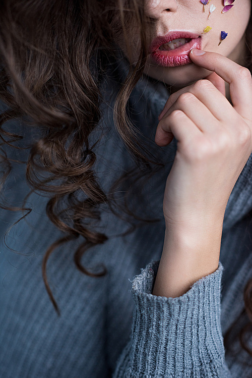 cropped shot of sensual young woman with flowers on face