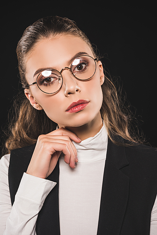 close-up portrait of beautiful brunette woman in eyeglasses  isolated on black