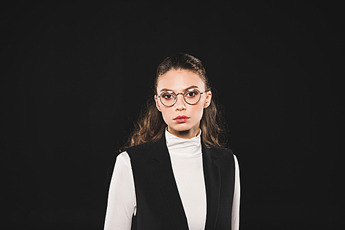 portrait of beautiful brunette woman in eyeglasses  isolated on black