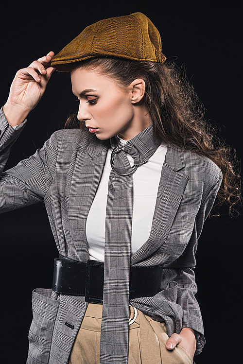 portrait of elegant fashionable young woman looking away isolated on black