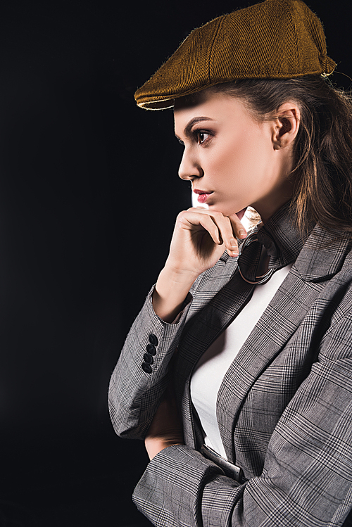 pensive elegant young woman looking away isolated on black