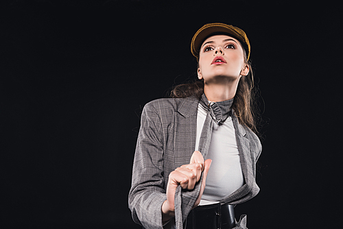 beautiful woman in elegant stylish jacket posing isolated on black