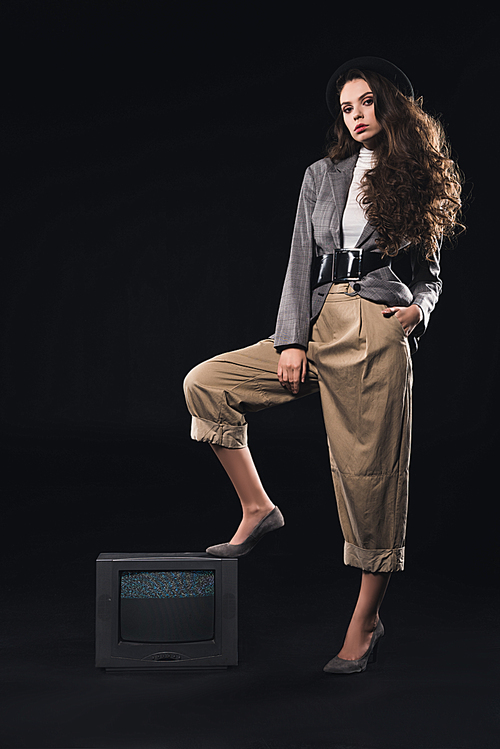 fashionable woman standing on tv with noises on the screen and  on black