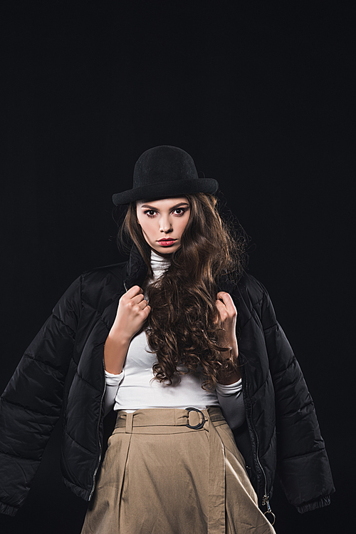 portrait of beautiful woman in hat and winter jacket  isolated on black