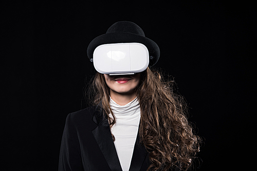 beautiful brunette woman using virtual reality headset isolated on black