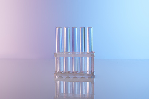 empty glass test tubes on blue background