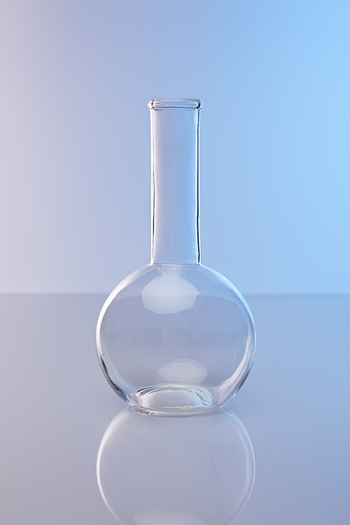 empty clean glass flask on blue background