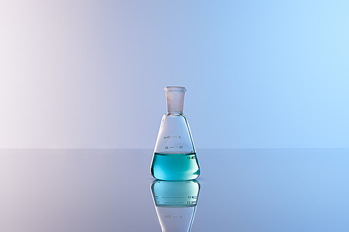 glass flask with blue colorful liquid