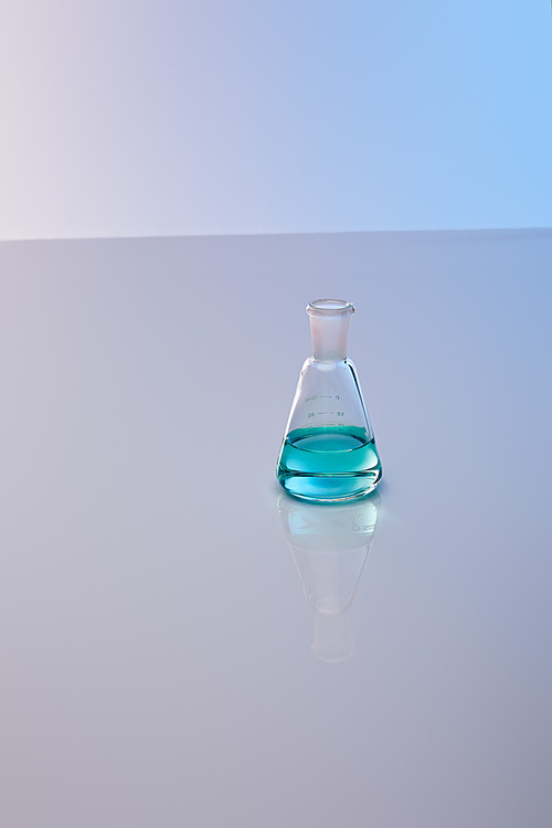 glass flask with blue colorful liquid