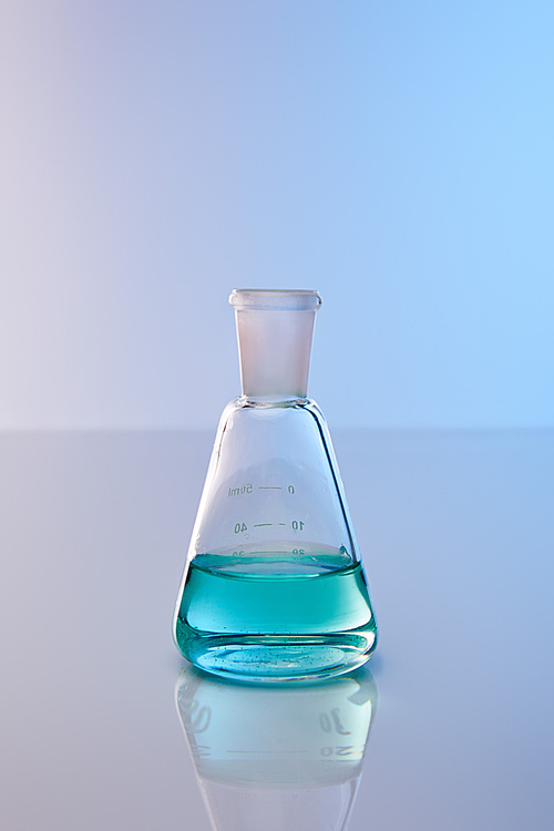 glass flask with blue colorful liquid