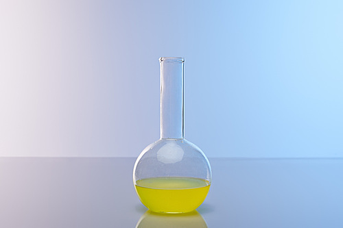 glass flask with colorful yellow liquid