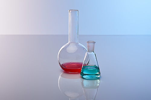 glass flasks with colorful blue and red liquid