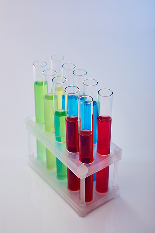 glass test tubes with colorful liquid on white background