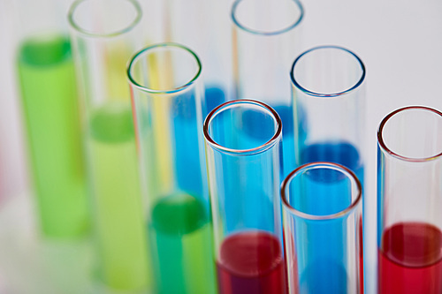 close up view of glass test tubes with colorful liquid