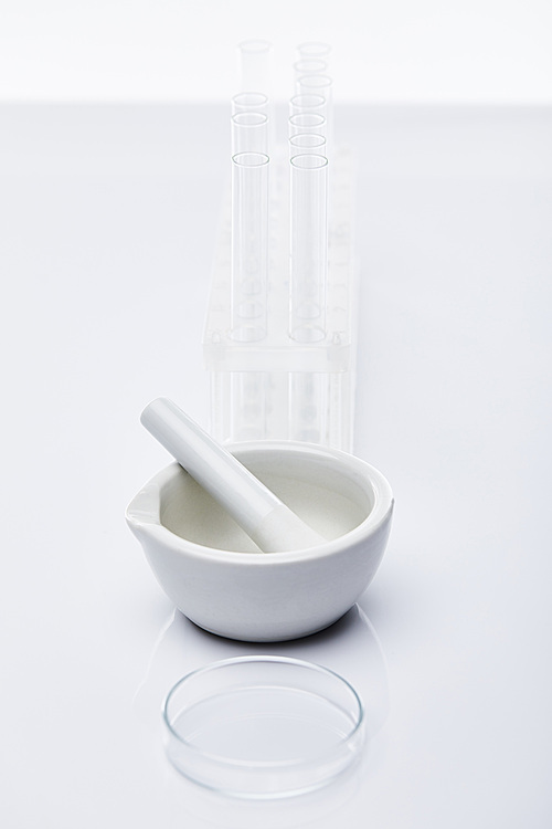 empty glass test tubes and mortar with pestle isolated on white