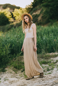 attractive elegant girl in dress and straw hat