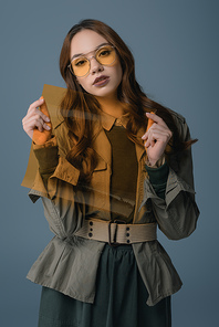 beautiful stylish girl posing in autumn outfit with filter for fashion shoot, isolated on grey