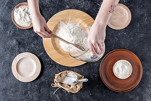 cropped shot of woman mixing ingredients while baking bread