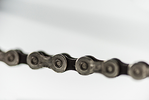 close up of bicycle metal chain on white