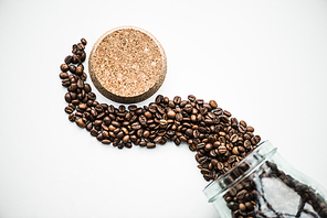 top view of wave from coffee beans and cork isolated on white