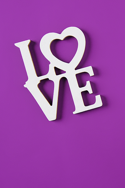 top view of word love isolated on purple, valentines day concept