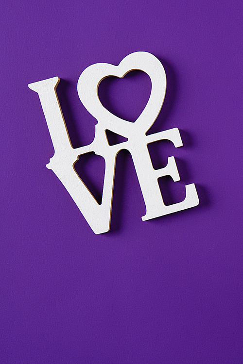 top view of word love isolated on purple, valentines day concept