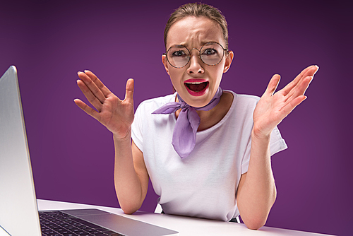 shocked girl gesturing with hands and  isolated on purple