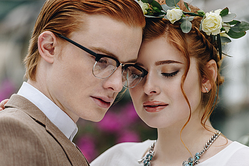 close-up portrait of beautiful tender young redhead wedding couple