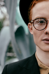 cropped shot of stylish man with red hair in hat 