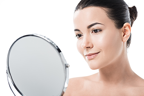 beautiful girl looking at table mirror isolated on white