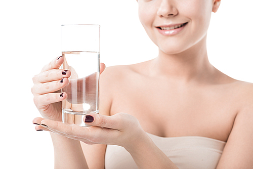 cropped image of beautiful smiling girl holding glass of water isolated on white