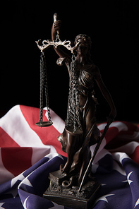 bronze statuette with scales of justice and american flag isolated on black