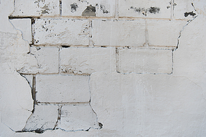 close-up view of white weathered brick wall texture