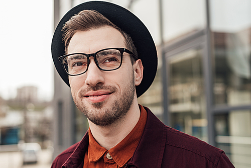 handsome fashionable man in eyeglasses and hat
