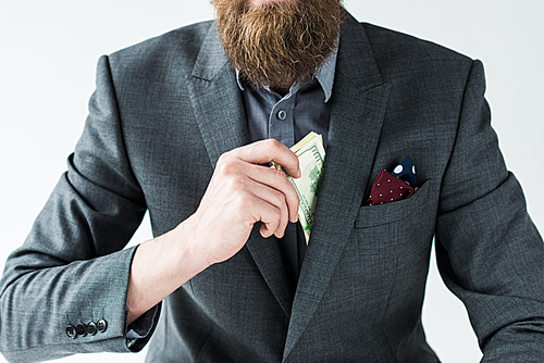 Cropped view of bearded man getting money out of pocket isolated on light background